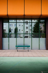 Empty road by building in city