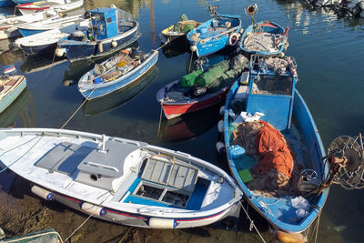 High angle view of fishing boats moored at harbor