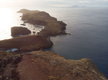 High angle view of rock formation in sea against sky