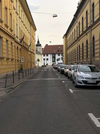 Street amidst buildings in city against sky