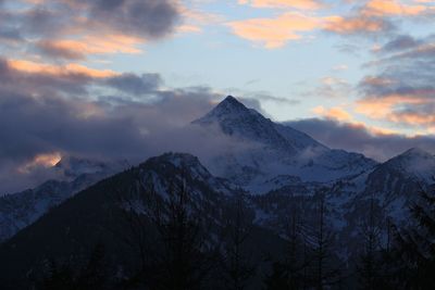 Scenic view of snowcapped mountains against sky during sunset