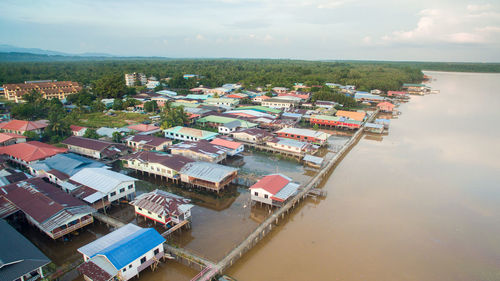 High angle view of buildings by sea against sky