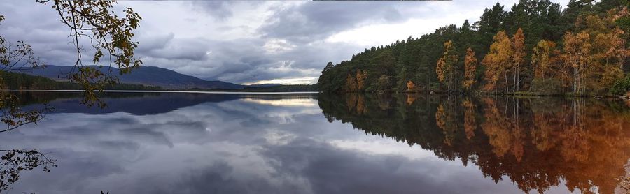 Panoramic view of lake and trees against sky