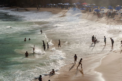 Large group of people on paciencia beach in the rio vermelho neighborhood of salvador, brazil. 