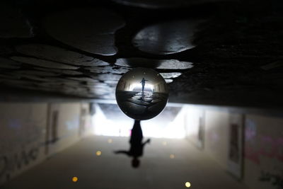 Close-up of illuminated lamp hanging on wall in building