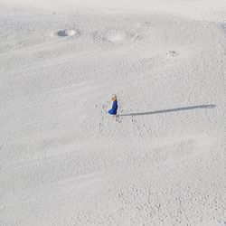 Man with umbrella on sand at beach