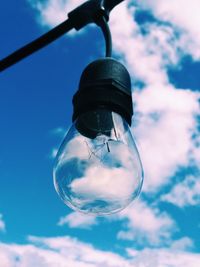 Low angle view of light bulb against sky