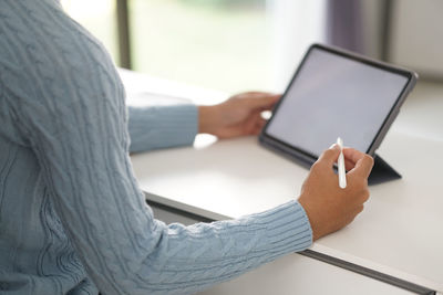 Close-up of hand holding mobile phone
