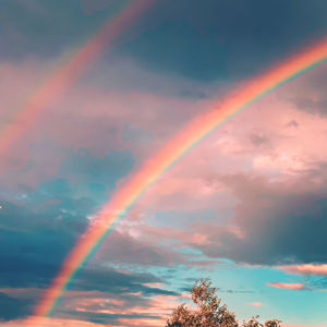 Low angle view of rainbow against sky during sunset
