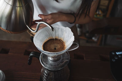 Barista dripping coffee and slow coffee wooden bar style