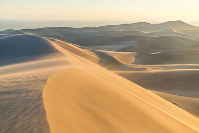 Scenic view of desert against sky during sunset