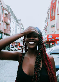 Portrait of smiling young woman in city