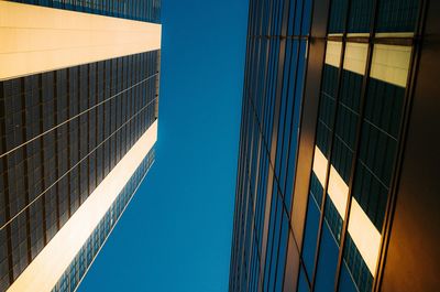 Low angle view of office building against blue sky