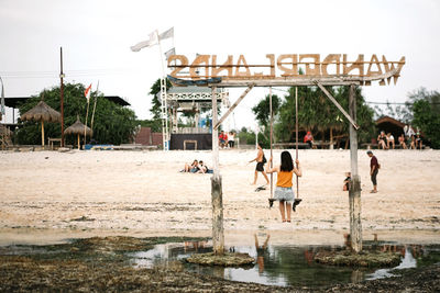 People at observation point against sky