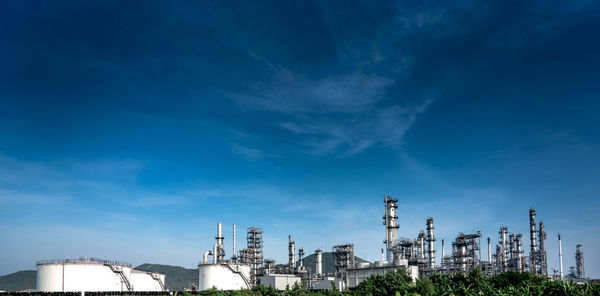 Low angle view of factory against blue sky