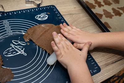 Cropped hands of woman holding food on table