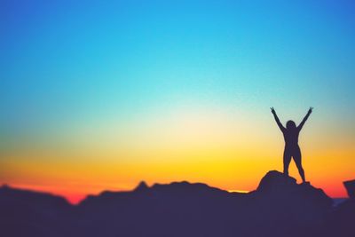 Silhouette woman against clear sky during sunset