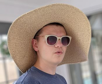 Portrait of teen boy wearing summer hat and sunglasses 