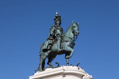 Statue against clear blue sky