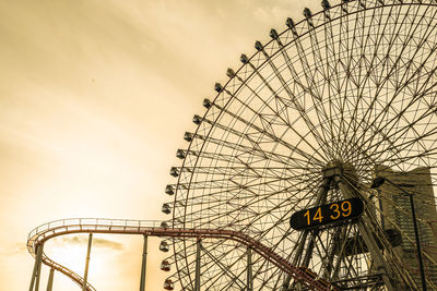 Low angle view of ferris wheel against sky