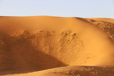 Scenic view of desert against clear sky