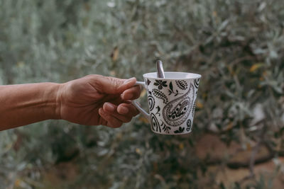 Hand holding coffee cup