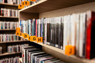 Books, audiobooks, radio dramas, and films on a shelf in a library. school readings. bookstore