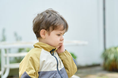 Expressive young boy playing in the back yard