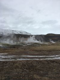 Scenic view of waterfall against sky