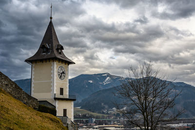 Low angle view of building and mountains against sky