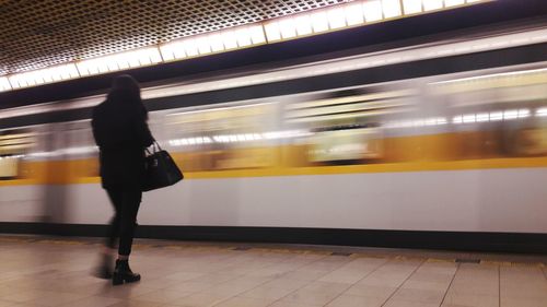 Blurred motion of woman at railroad station