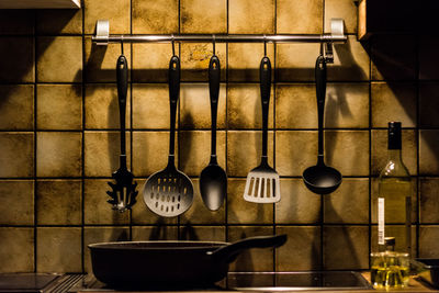 Cooking utensils hanging on wall at home