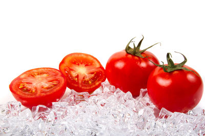 Close-up of tomatoes against white background