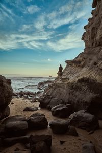 Rocks on beach against sky