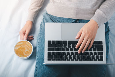 High angle view of man using laptop on table