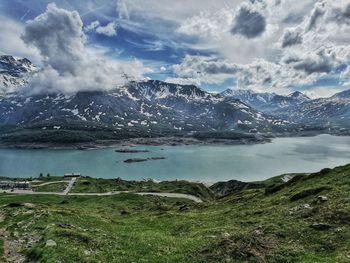 Scenic view of lake by mountains against sky