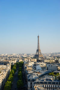 Aerial view of buildings in city against clear sky