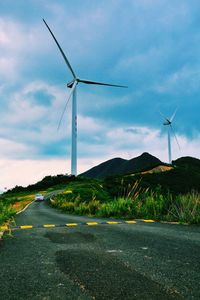 Windmill on field against sky