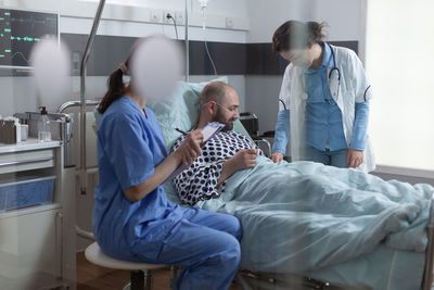 Female doctors examining patient in clinic