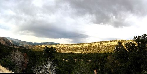 Scenic view of mountains against cloudy sky