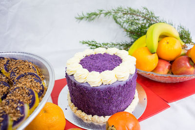 Close-up of cake and fruits on table during christmas