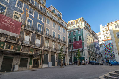 View of city street and buildings against sky