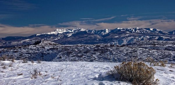Scenic view of snowcapped mountains against sky