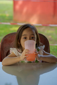 Portrait of girl drinking water