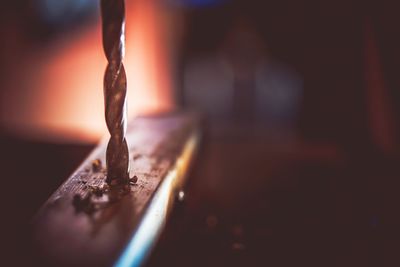 Close-up of burning candles on metal