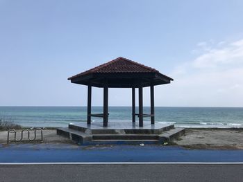 Lifeguard hut on beach against clear sky