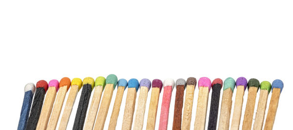 Close-up of colored pencils against white background