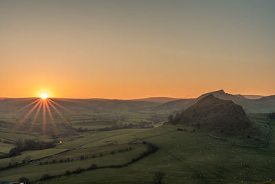 Scenic view of landscape against clear sky during sunset