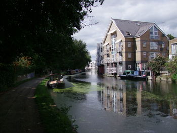 River amidst buildings against sky