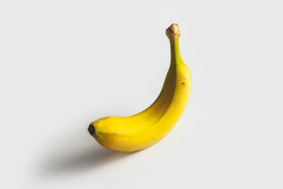 Close-up of yellow fruit against white background